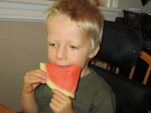 Sucking the juice from a watermellon slice... yum!  