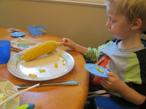 Corn caterpillars...  we cut the niblets off the cob and made caterpillars.  Henry tasted each and every one of them and then spit them onto his side plate.